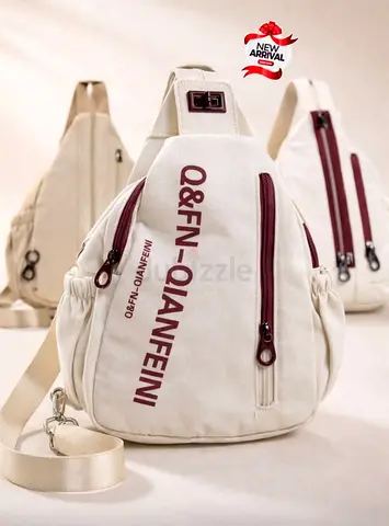 This QFN - Qianfeini branded beige chest bag features prominent brand lettering and maroon zipper .