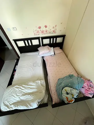 Two single wooden bed frames with headboards and mattresses - good condition