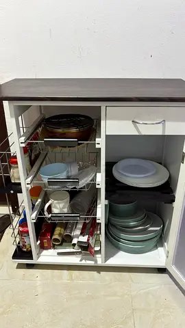 Compact kitchen storage cabinet with pull-out shelves, drawer and storage options