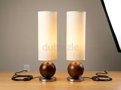 Pair of modern table lamps with wooden sphere bases and tall fabric shades