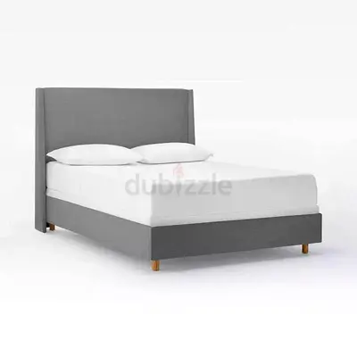 Light gray wingback queen bed with mattress