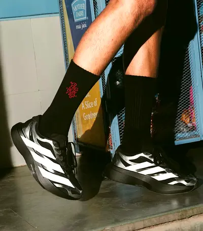 Black mid-calf socks with red embroidered logo - gently used