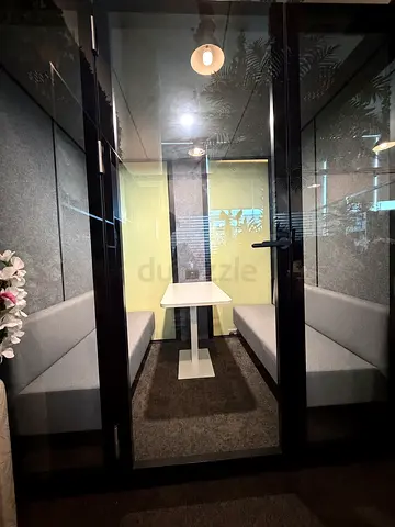 Private Glass Meeting Booth with Built-in Benches and Table