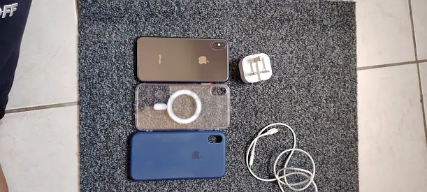 iPhone with charger, cable and two cases - good working condition