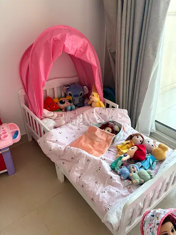 White toddler/mini crib with pink canopy and bedding does not include stuffed toys (not used at all)
