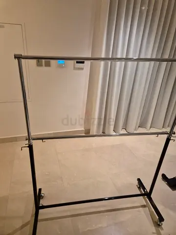 Portable metal garment rack on wheels - adjustable hanging rail
