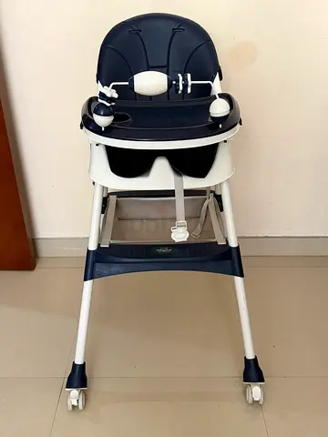 Used baby high chair with tray and safety straps - good condition