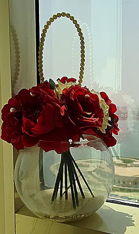 Glass bowl vase with artificial red rose arrangement and pearl handle