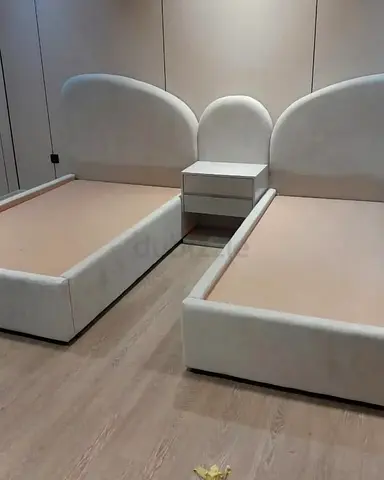 Pair of upholstered single beds with shared nightstand — modern design