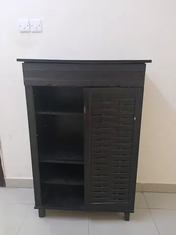 Compact Black Wooden Cabinet with Shelves and used as a shoe rack.