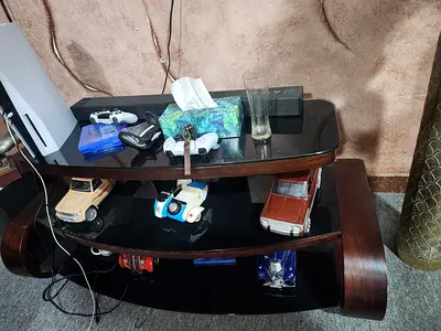 Black glass table with brown wooden frame
