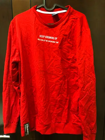 Red crewneck sweatshirt with graphic text