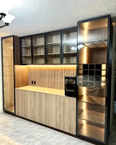 Custom built-in wooden entertainment/storage unit with glass display and lighting
