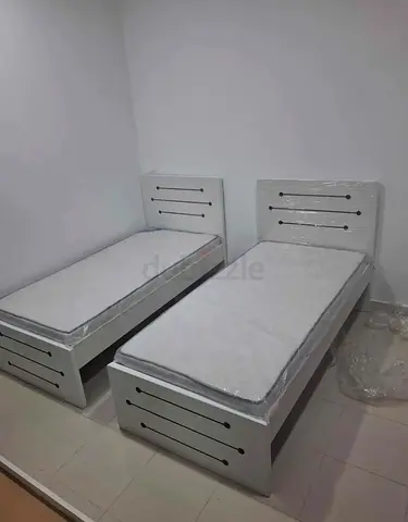 Pair of white single beds with mattresses - good condition