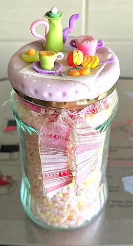 Decorative glass jar with handmade clay tea set lid