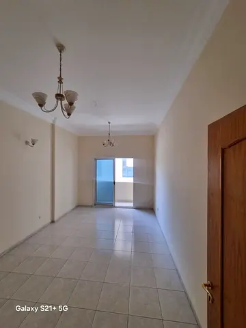 For rent in Al Qasimia (Station), Sharjah: 1-bedroom apartment with balcony and central AC, opposite the park. First year AED 30,000 + 1 month free, 4