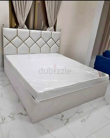 White upholstered double bed with storage and padded headboard