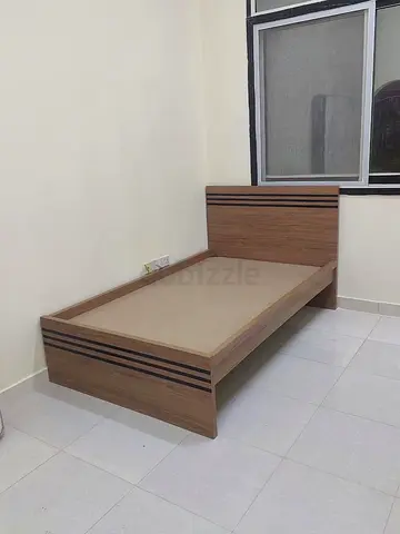 Single wooden bed frame with headboard — good condition