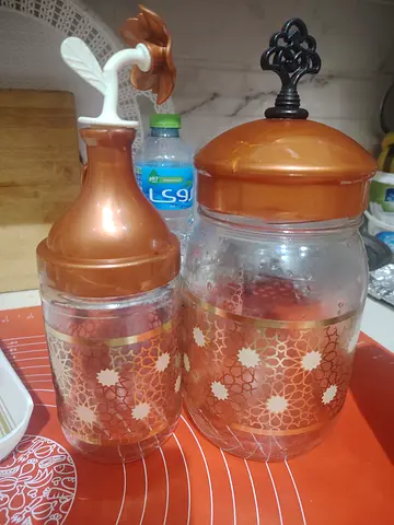 Pair of decorative kitchen storage jars with lids
