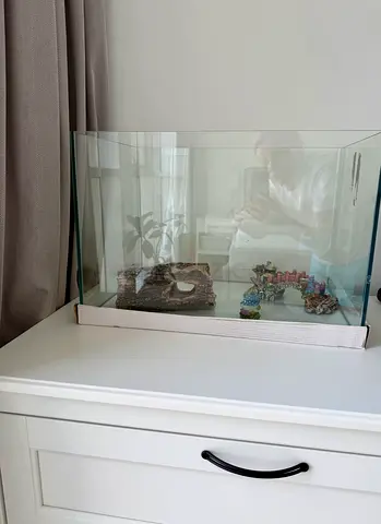Glass aquarium tank with decorations — good condition