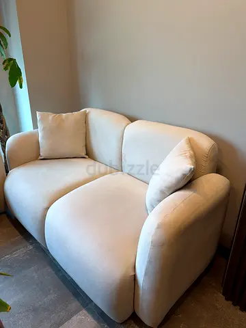 Light beige 2-seater compact sofa in excellent condition 2 pieces + table