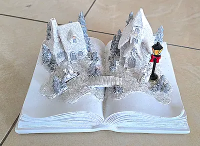 Hand-painted winter village book decoration — white glitter scene