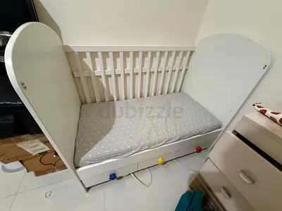 White wooden baby crib with under-drawer storage, gently used