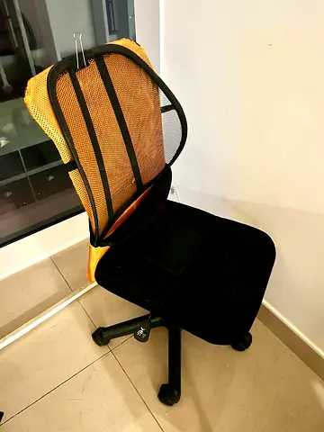Black revolving chair with lumbar support
