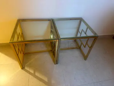 2 glass-top gold metal nesting side tables