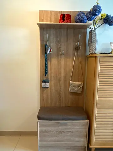 Shoe rack closet with seating chair.