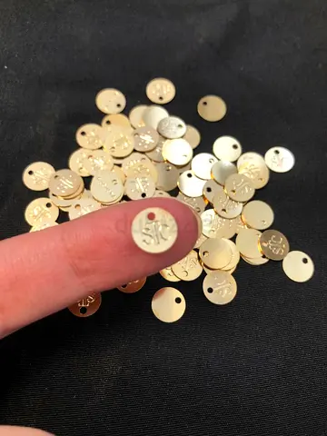 Small round gold-tone metal logo tags (pack of 50+)