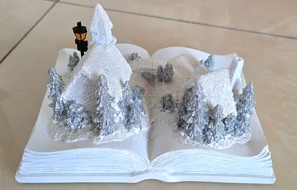Hand-painted winter village book decoration — white glitter scene