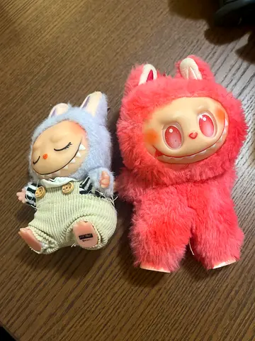 Pair of collectible plush dolls - pink and blue outfits, good condition