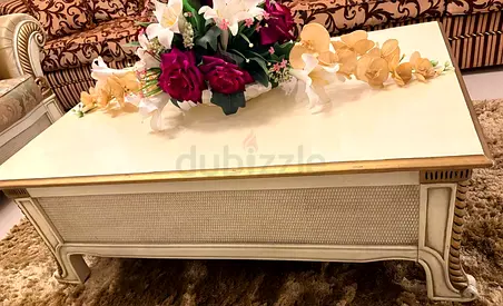 Classic cream wooden coffee table with gold trim and artificial flowers - good condition
