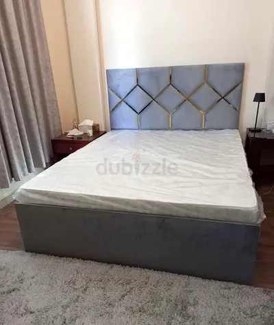 Grey upholstered double bed with padded headboard - good condition