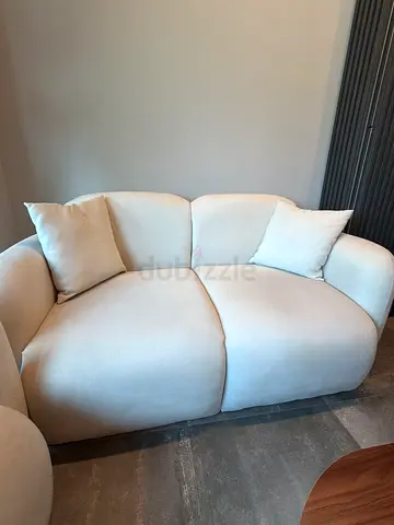 Light beige 2-seater compact sofa in excellent condition 2 pieces + table