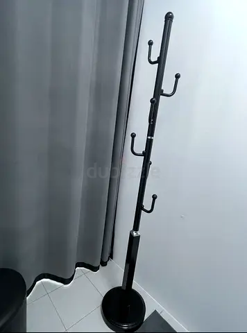 Black freestanding coat rack with multiple hooks - good condition