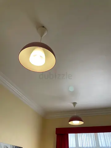 Pair of red dome shaped ceiling-mounted lights
