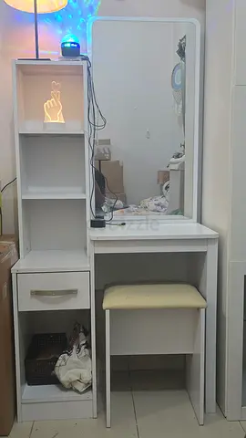 White vanity dressing table with mirror and cushioned stool and a 6 shelf display cabinet