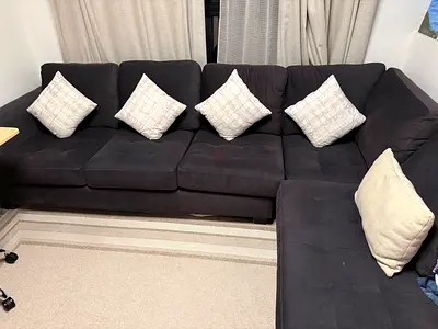 L-shaped dark grey fabric corner sofa (cushions excluded)