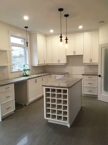 Modern white kitche. Island with storage and wine racks