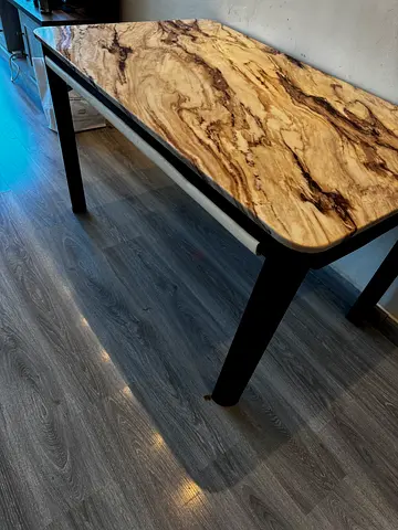 Solid granite dining table with black legs - good condition