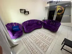 Furnished one-bedroom apartment with living room, two bathrooms, and balcony for rent in Al Taawun.