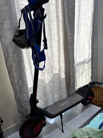 Lightly used electric scooter with helmet and backpack included