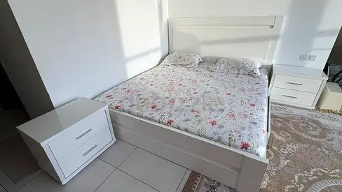 White wooden double bed frame with headboard and 2 bedside tables with medicated mattress