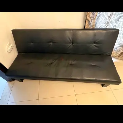Black faux leather 3-seater sofa bed / futon (used)
