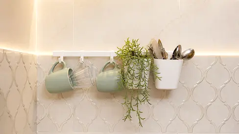 Wall-mounted kitchen rail with hooks and utensil holder