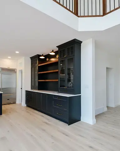 Dark built-in kitchen/display cabinets with shelving and drawers