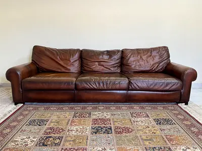Three-seater brown leather sofa in good used condition