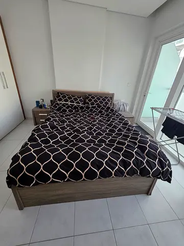 Queen bed frame with mattress and bedside table - light wood